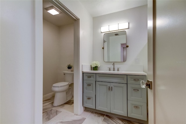 bathroom with vanity and toilet