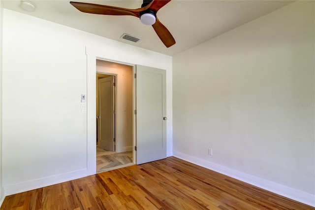 empty room with ceiling fan and light wood-type flooring