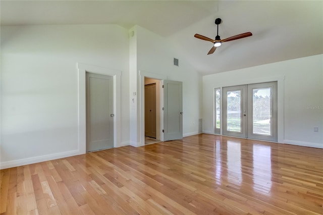 empty room featuring ceiling fan, french doors, high vaulted ceiling, and light hardwood / wood-style floors