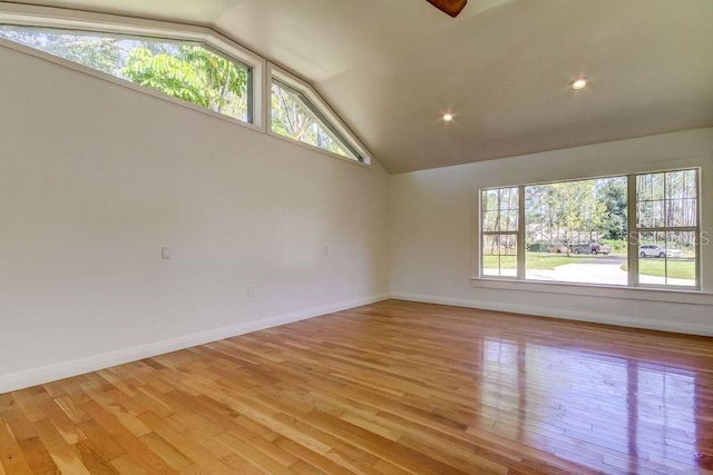 unfurnished room featuring light hardwood / wood-style flooring and lofted ceiling