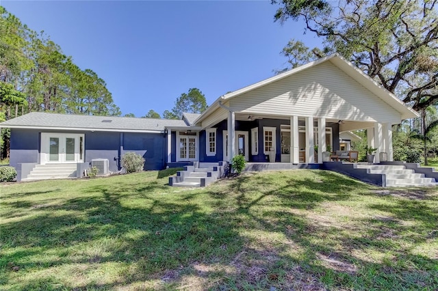 rear view of house with french doors, a yard, and central air condition unit