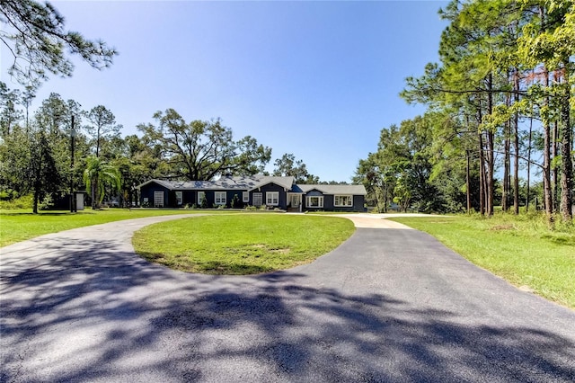 ranch-style home featuring a front yard