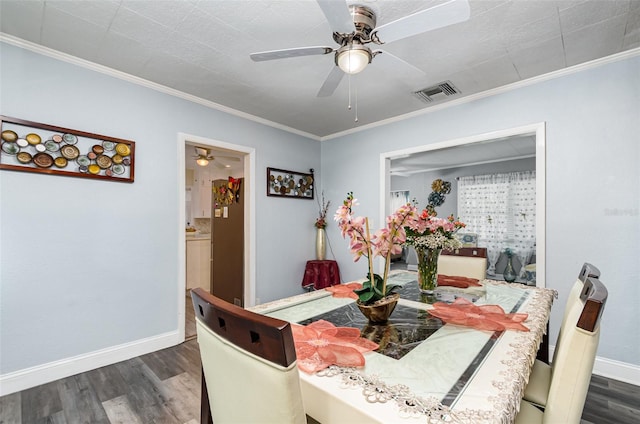 dining area featuring crown molding and dark wood-type flooring