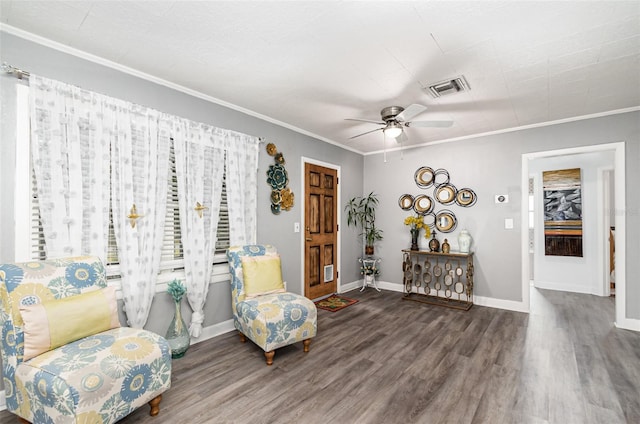 living area with hardwood / wood-style flooring, ceiling fan, and ornamental molding