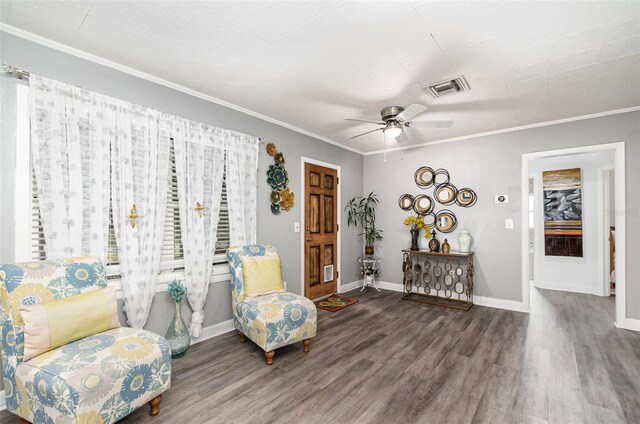 323 NW 25th St, Ocala, FL 34475 - living area with wood finished floors, visible vents, a ceiling fan, and ornamental molding