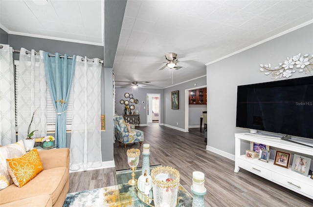 living room featuring hardwood / wood-style floors, ceiling fan, and ornamental molding