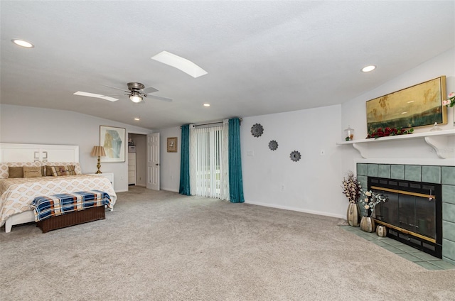 bedroom with a fireplace, light colored carpet, ceiling fan, and lofted ceiling