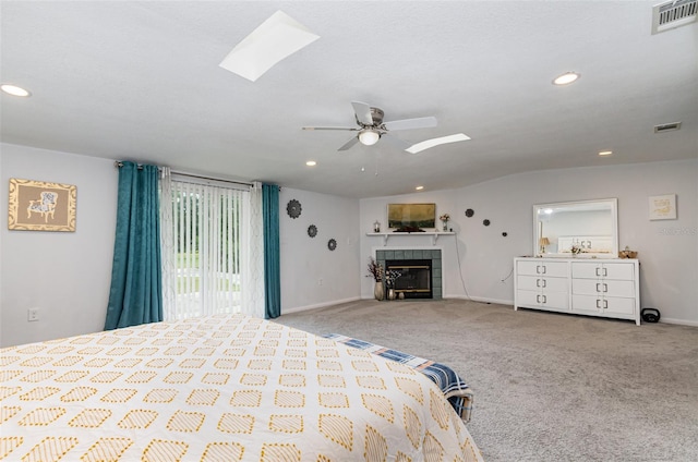 unfurnished bedroom with lofted ceiling, access to outside, ceiling fan, a fireplace, and light colored carpet