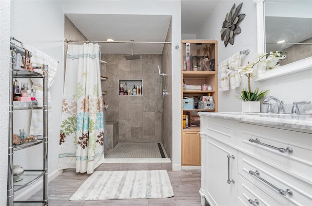 bathroom featuring vanity and curtained shower