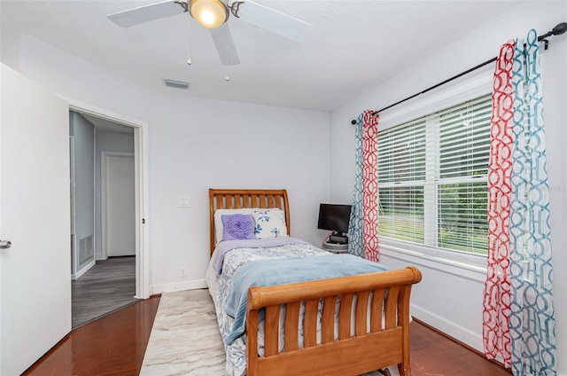 bedroom featuring dark hardwood / wood-style flooring and ceiling fan