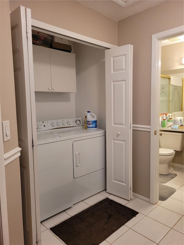 2351 Bentley Dr, Palm Harbor, FL 34684 - washroom with cabinet space, independent washer and dryer, and light tile patterned flooring