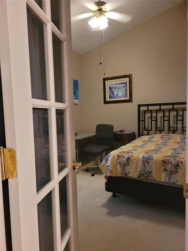 bedroom featuring ceiling fan, carpet floors, french doors, and a textured ceiling