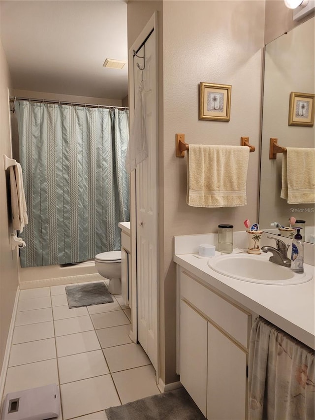 bathroom with a shower with shower curtain, tile patterned flooring, vanity, and toilet