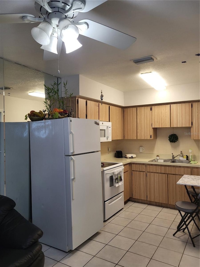 kitchen with backsplash, white appliances, ceiling fan, sink, and light tile patterned flooring