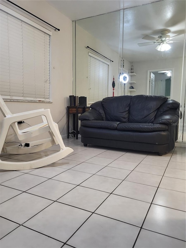 living room with light tile patterned floors and ceiling fan