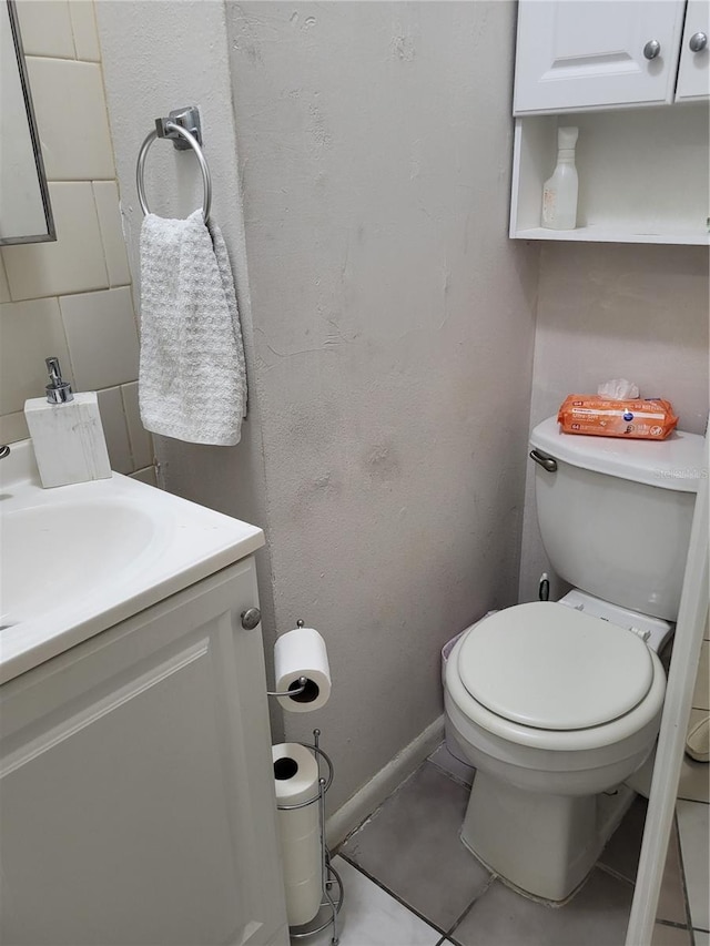 bathroom with tile patterned floors, vanity, and toilet