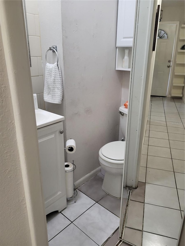 bathroom featuring tile patterned flooring, vanity, and toilet