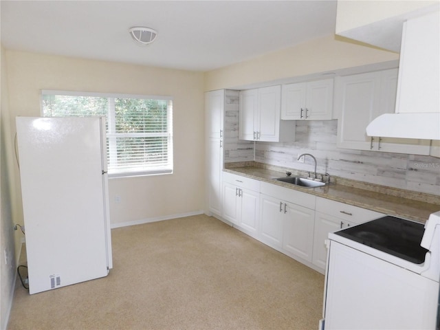 kitchen with range, sink, extractor fan, white cabinetry, and white refrigerator