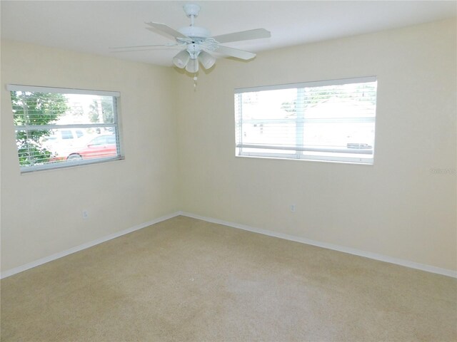 unfurnished room with carpet and ceiling fan