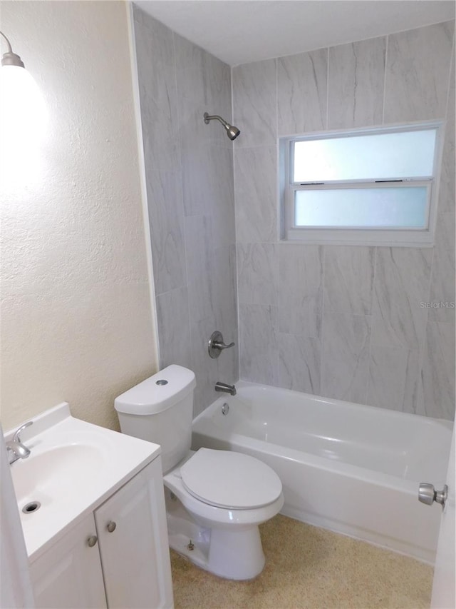 full bathroom with tiled shower / bath combo, vanity, and toilet