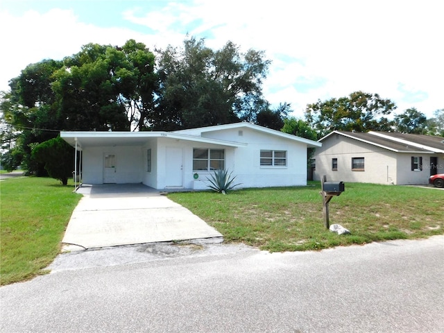 single story home featuring a carport and a front lawn