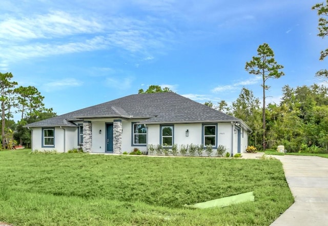 view of front of property featuring a garage and a front yard