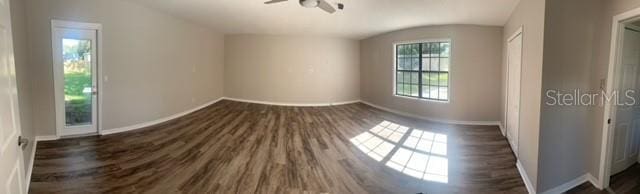 interior space with ceiling fan and dark hardwood / wood-style flooring