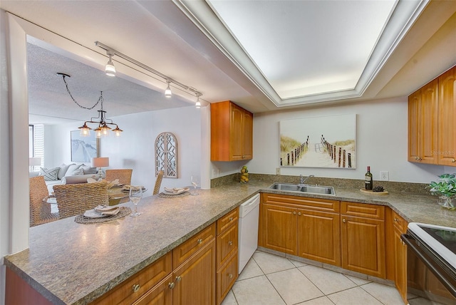 kitchen featuring sink, an inviting chandelier, white dishwasher, rail lighting, and electric range