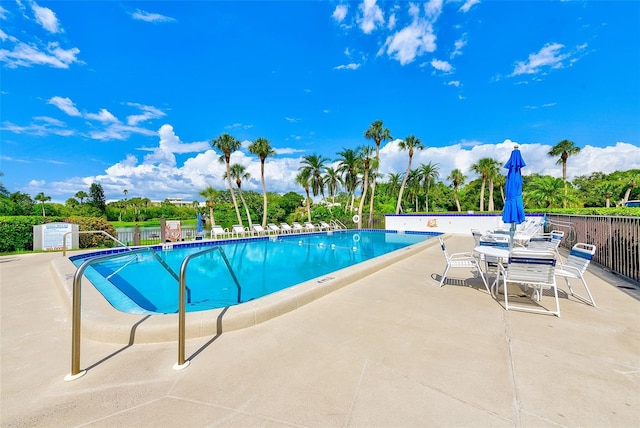 220 Belleview Blvd Unit 802, Belleair, FL 33756 - community pool featuring a patio area and view of wooded area