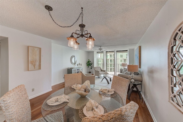 dining space with floor to ceiling windows, a textured ceiling, dark hardwood / wood-style flooring, and an inviting chandelier