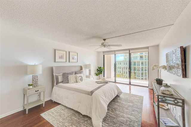 bedroom with a wall of windows, a textured ceiling, ceiling fan, and access to outside