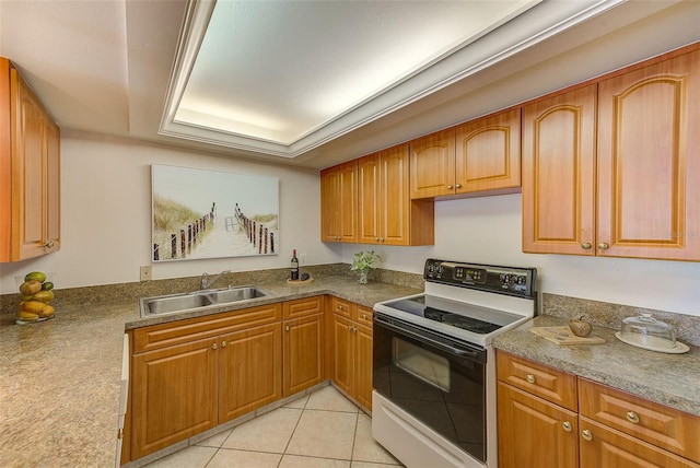 kitchen with range with electric cooktop, a tray ceiling, light tile patterned floors, and sink