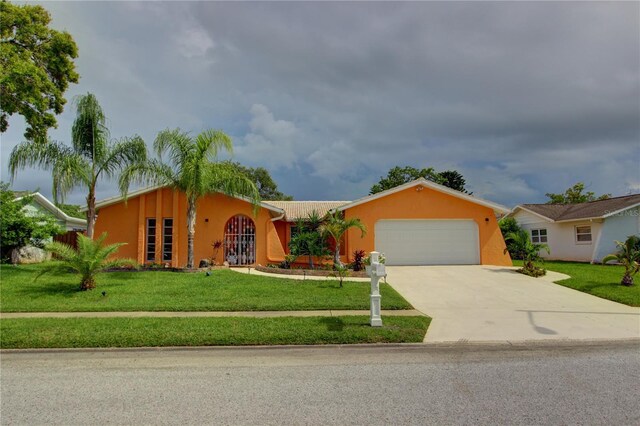 ranch-style home featuring a garage and a front lawn