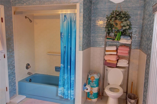 bathroom with tile patterned flooring, toilet, and shower / bathtub combination with curtain