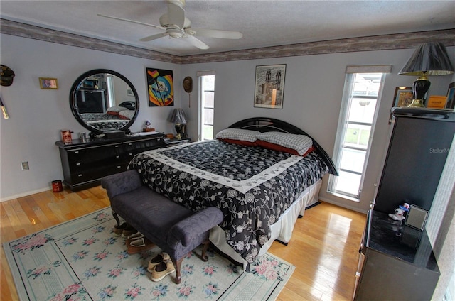 bedroom featuring light wood-type flooring and ceiling fan