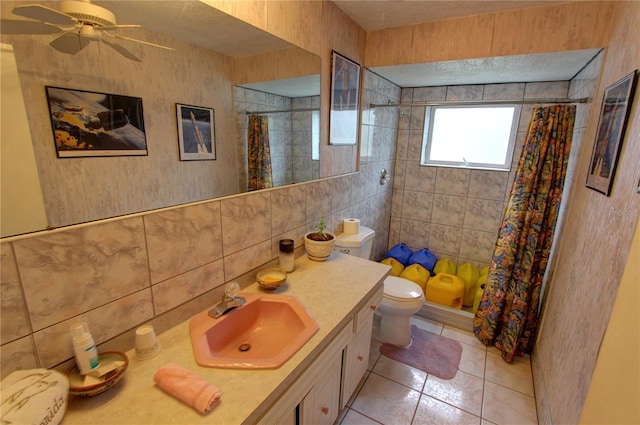 bathroom with tile walls, vanity, toilet, and walk in shower