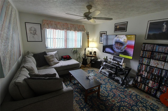 living room featuring ceiling fan and a textured ceiling