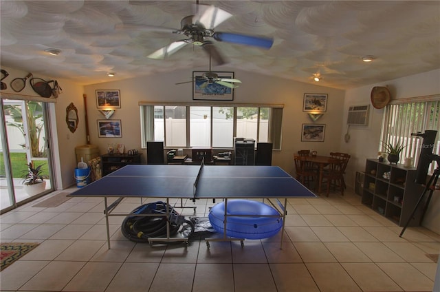 rec room featuring a wall mounted AC, light tile patterned floors, ceiling fan, and vaulted ceiling