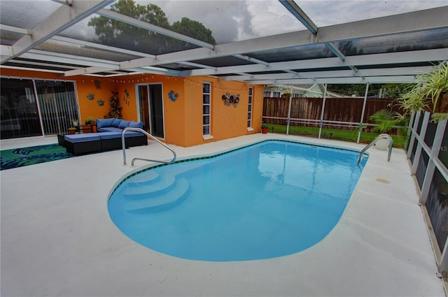 view of pool featuring a patio, an outdoor living space, and glass enclosure