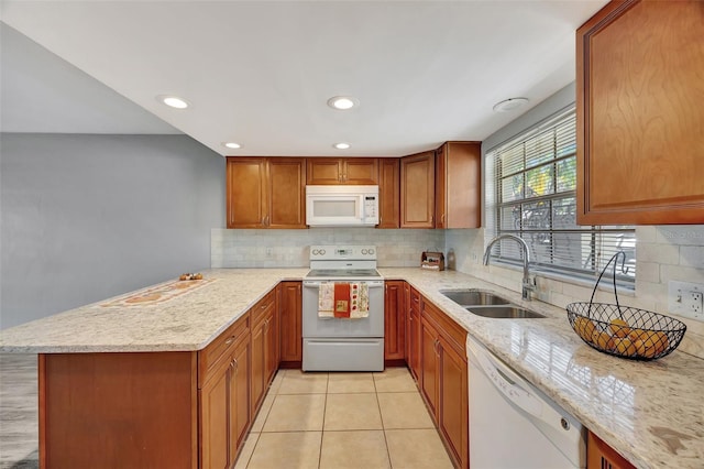 kitchen featuring decorative backsplash, light stone counters, white appliances, sink, and light tile patterned floors