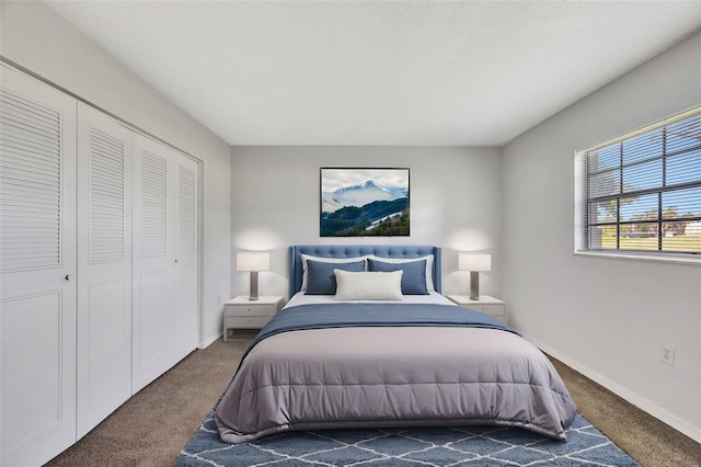 carpeted bedroom with a closet and a textured ceiling