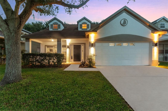 view of front of home featuring a garage and a lawn