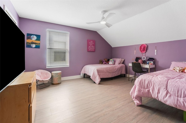 bedroom with light hardwood / wood-style flooring, ceiling fan, and vaulted ceiling