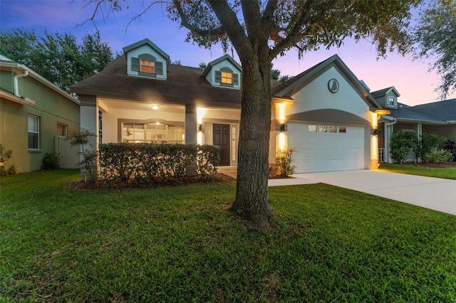 view of front of home featuring a garage and a yard