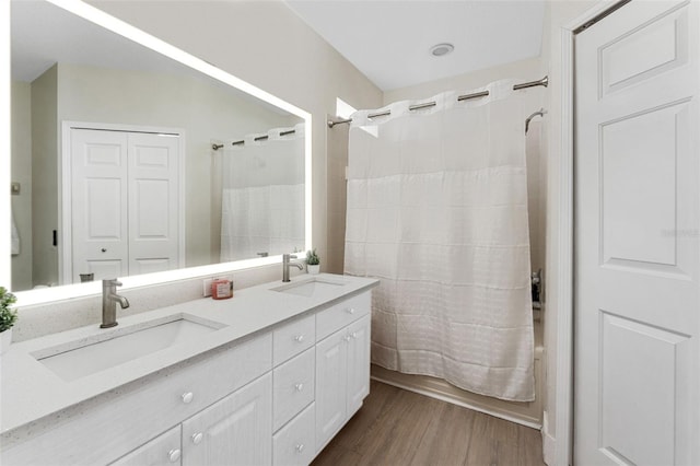 bathroom featuring vanity, hardwood / wood-style floors, and shower / bath combination with curtain