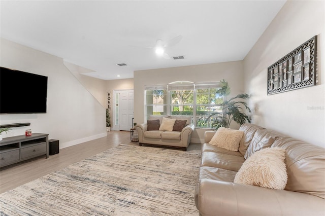 living room with wood-type flooring and ceiling fan