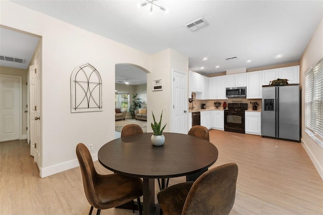 dining space with light hardwood / wood-style floors