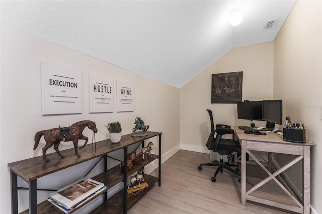 office space with lofted ceiling and hardwood / wood-style floors