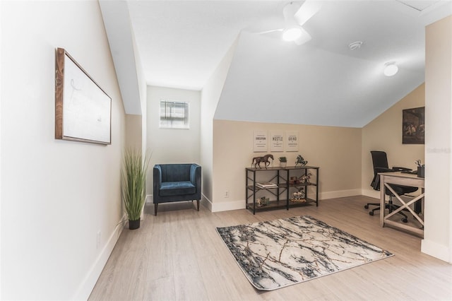 home office featuring ceiling fan, vaulted ceiling, and light hardwood / wood-style flooring