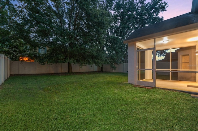 view of yard at dusk